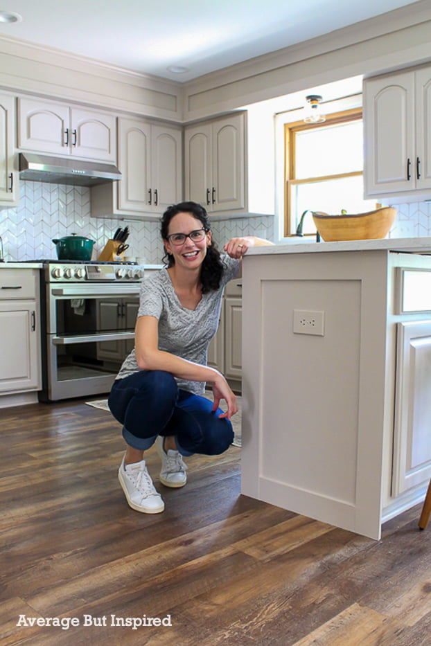 See how she added style to builder grade kitchen cabinets with DIY cabinet end panels.