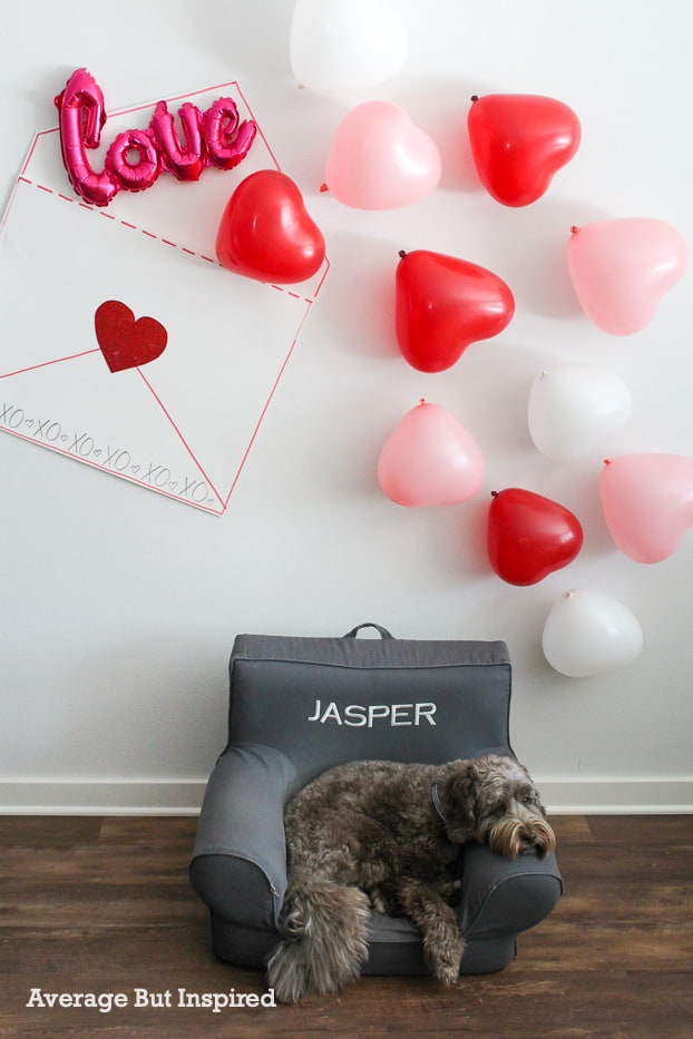Make a super cute love note DIY Valentine's Backdrop for your Valentine's Day party! This easy DIY photo backdrop comes together quickly and is so cute!