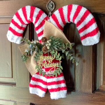 Dollar Tree wreath forms and socks are turned into an adorable candy cane wreath!