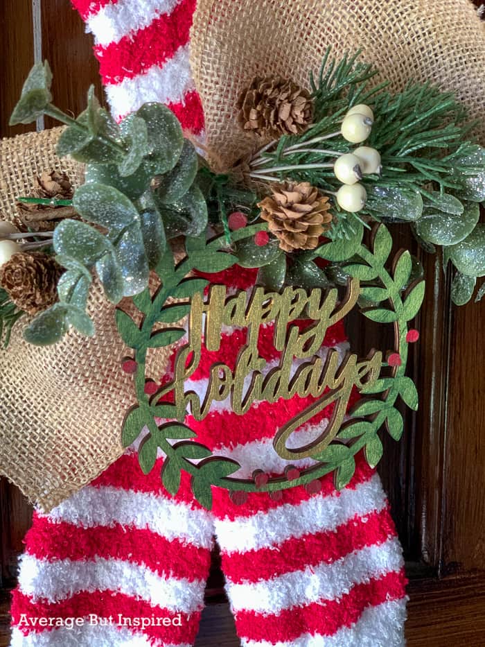 Pretty greenery and an ornament dress up a dollar store DIY wreath.