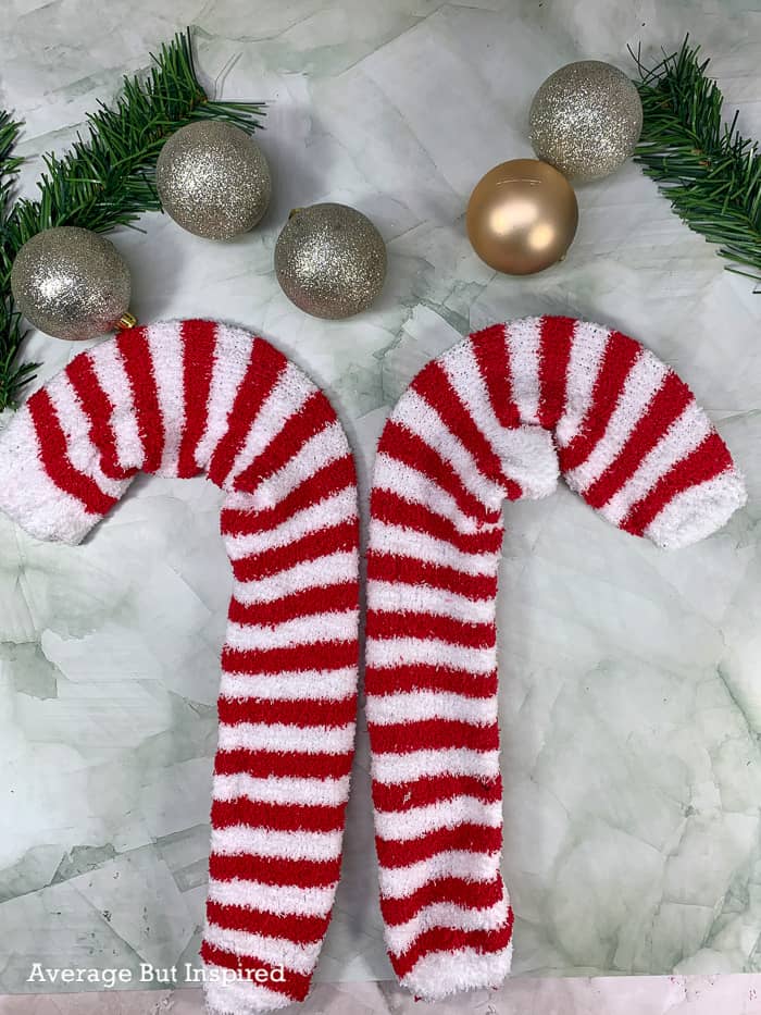 Use Dollar Tree's candy cane wreath forms and plush socks to make an adorable DIY candy cane wreath.