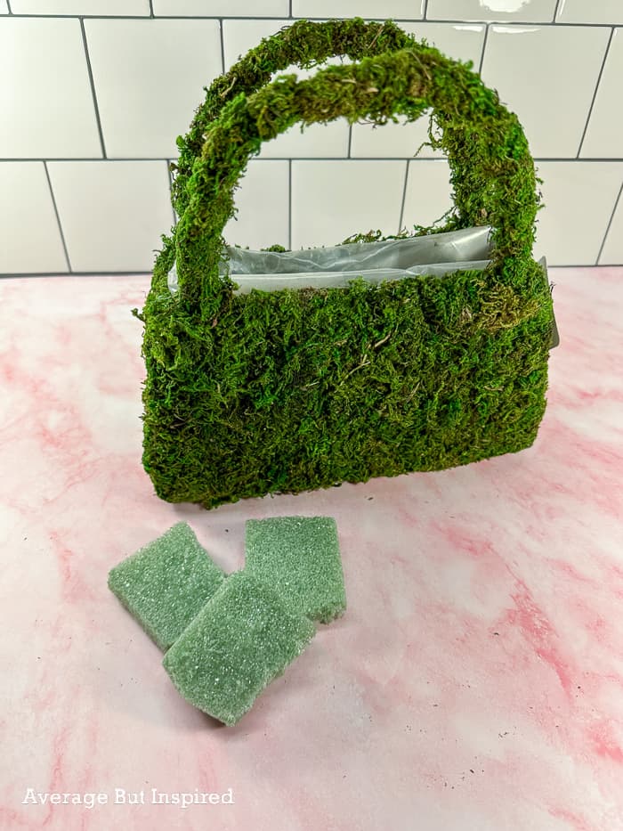 Put floral foam inside the moss purse.