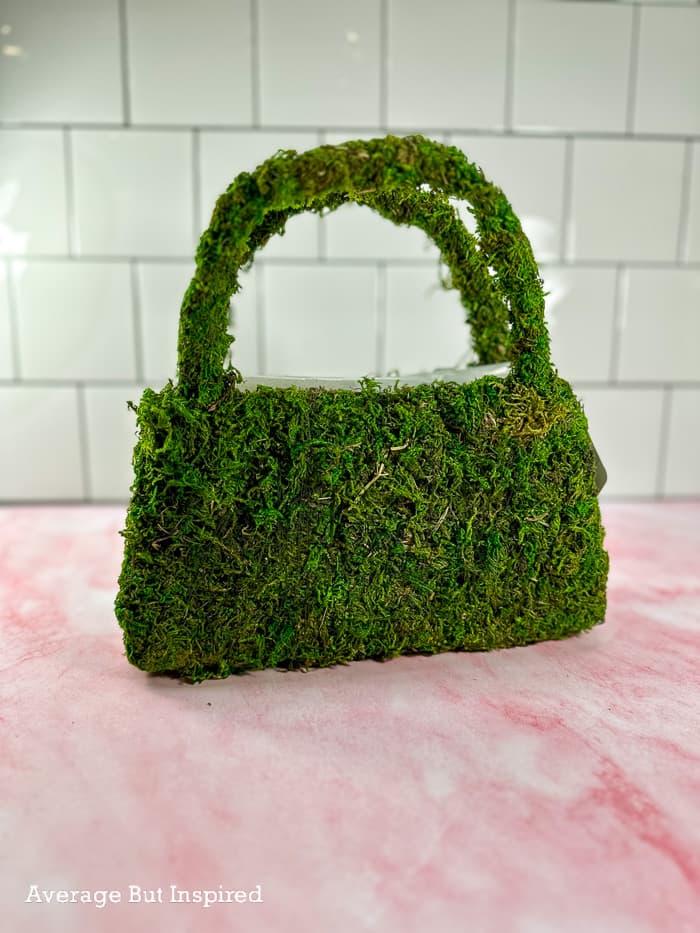 A moss purse form can be embellished to become a pretty spring wreath or table centerpiece.