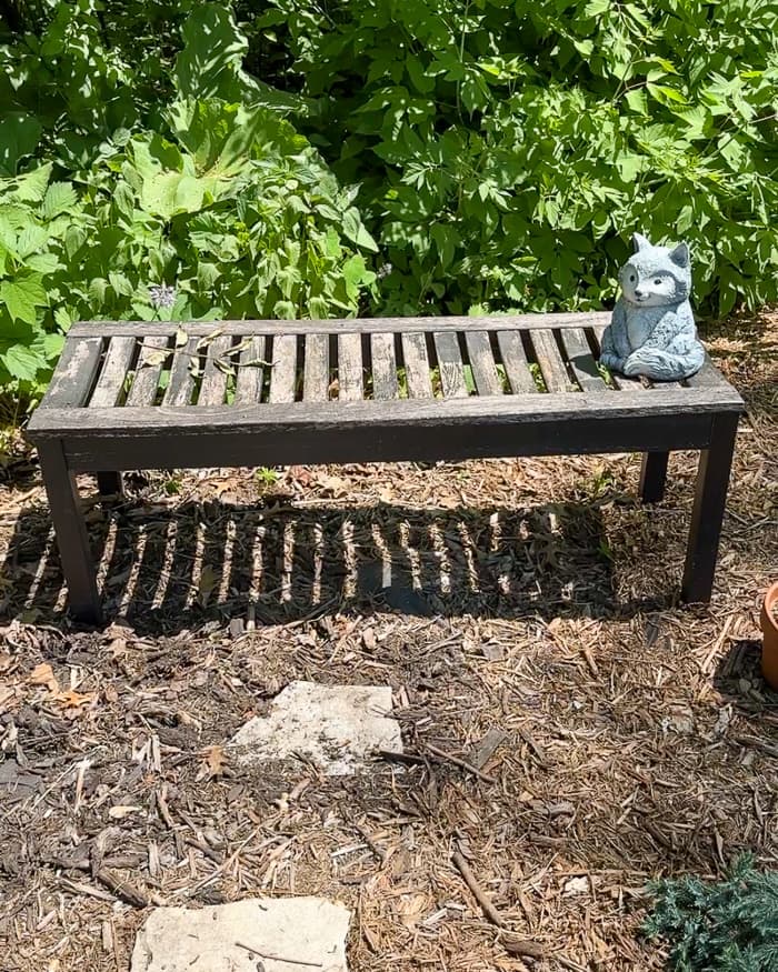 BEFORE: an outdoor wood bench was sun and water damaged before she refinished it with exterior wood stain.