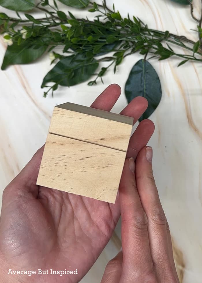 A shallow slit cut into a craft wood cube will serve as a picture holder.