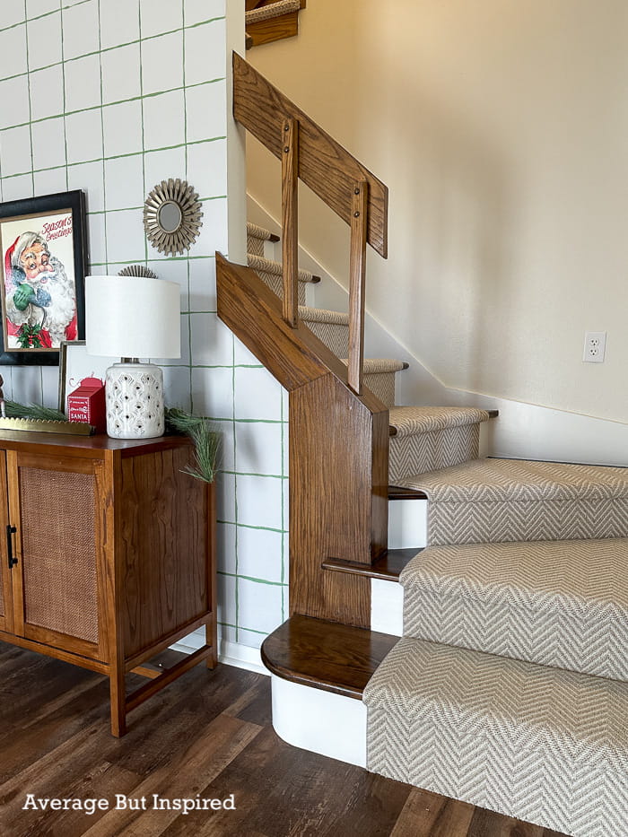 A modern stair runner in a subtle chevron pattern was installed on a 1970s staircase to give it a transitional feel. The runner is by Stanton and the pattern is Wishbone.