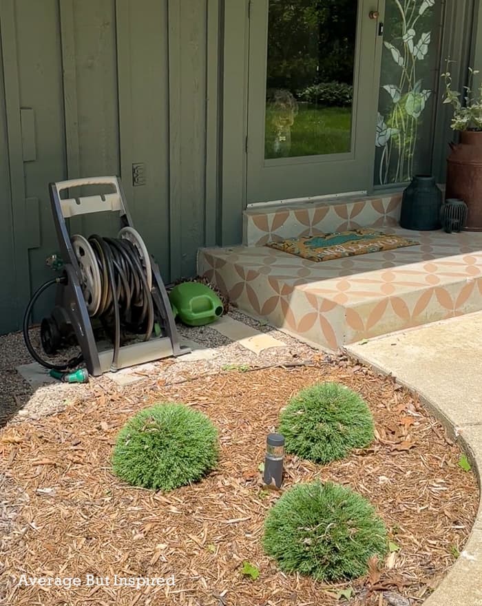 BEFORE: a traditional garden hose cart was unsightly at this home's front porch.