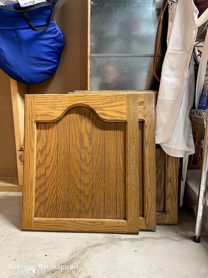 Old cabinet doors are upcycled into a beautiful wall-mounted headboard. Learn how to repurpose cabinet doors in this post.
