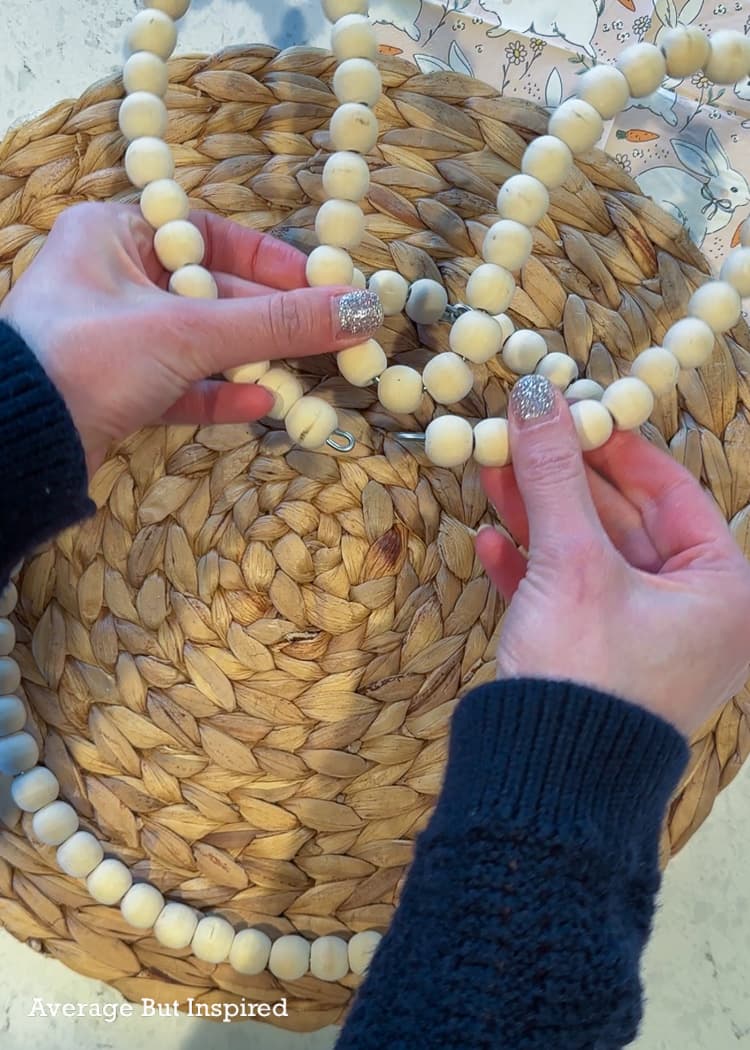 Dollar Tree wood bead wreaths can be turned into the cutest spring door decor. Bend one of the wreaths into the shape of ears.