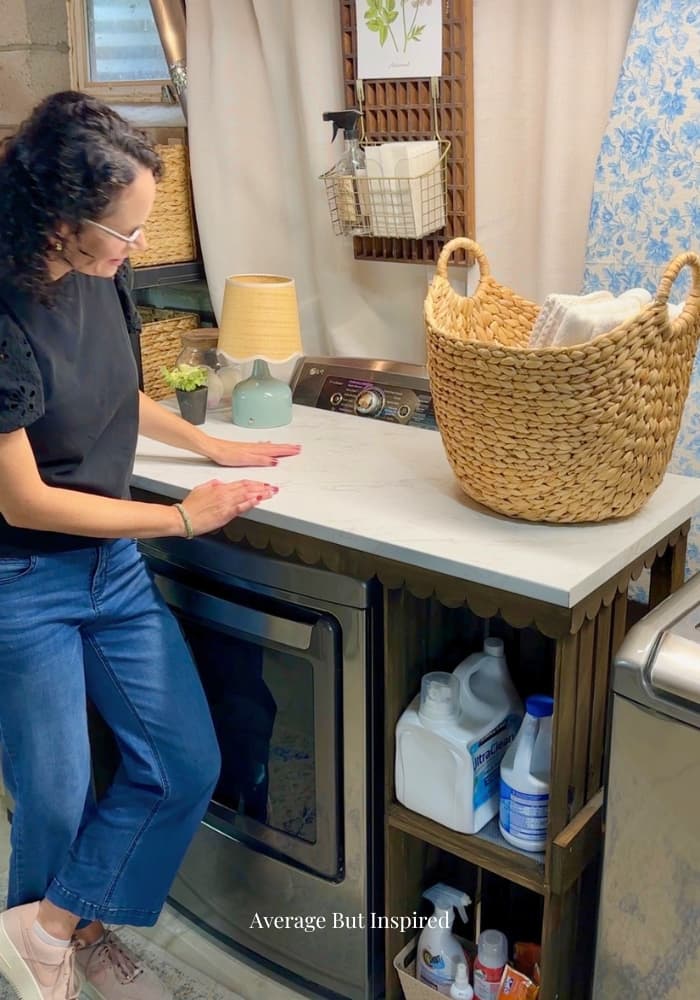 A DIY laundry countertop made with crates, wood, and a laminate countertop.